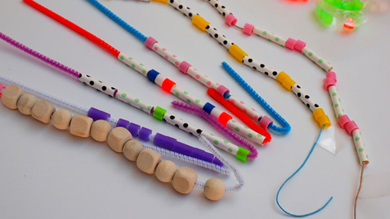 Different bracelets with colorful beads in repeating patterns.