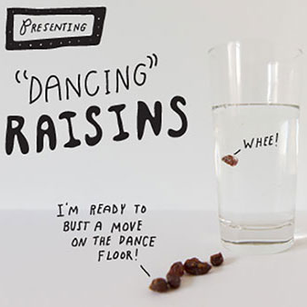 Glass full of water with some raisins