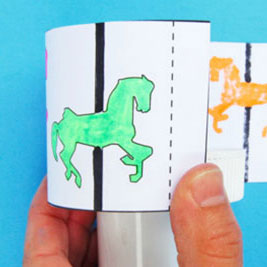 Horses on a paper version of a carousel.