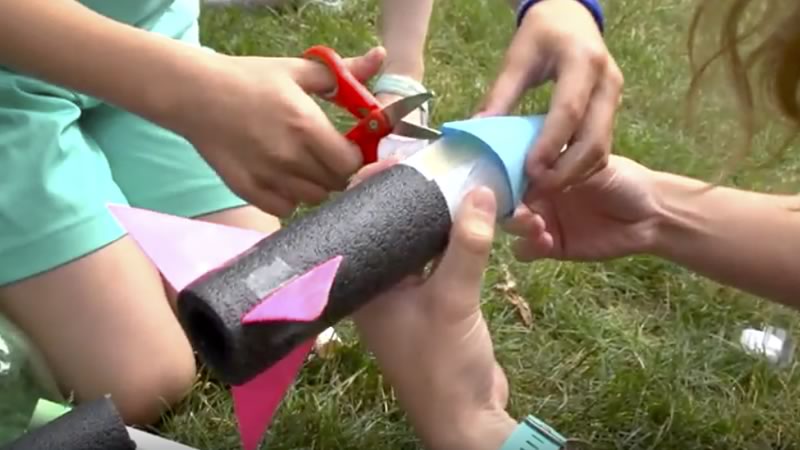 Kids building an air pressure rocket out of foam