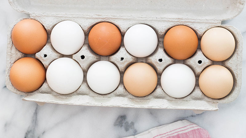 Overhead picture of a box of a dozen eggs.